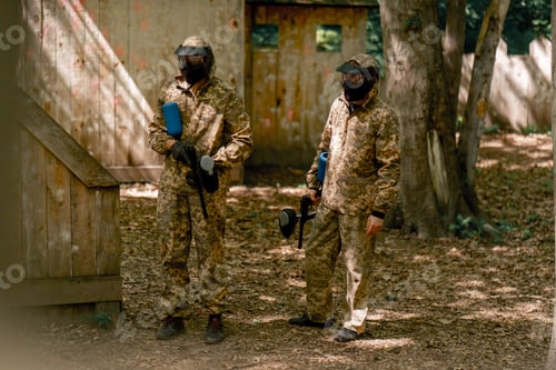 Preview: in the wild near the fences players in pinball uniforms hold a gun with blue balloon in camouflage