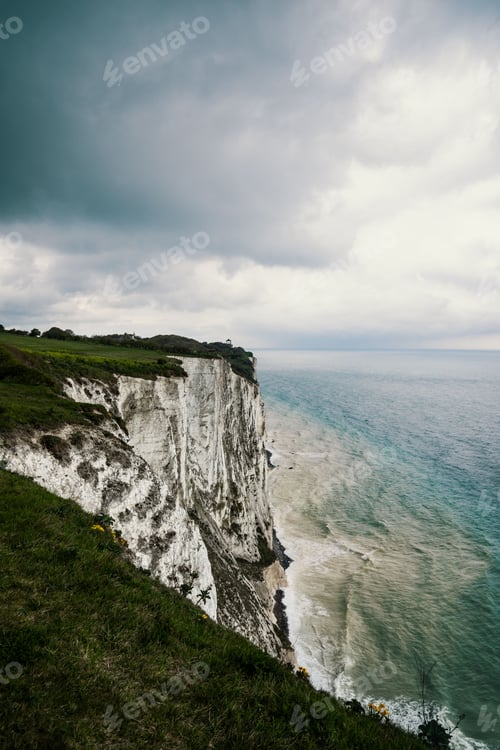 Preview: View of the White Cliffs of Dover surrounded by the sea under gloomy cloudy sky in Kent, England
