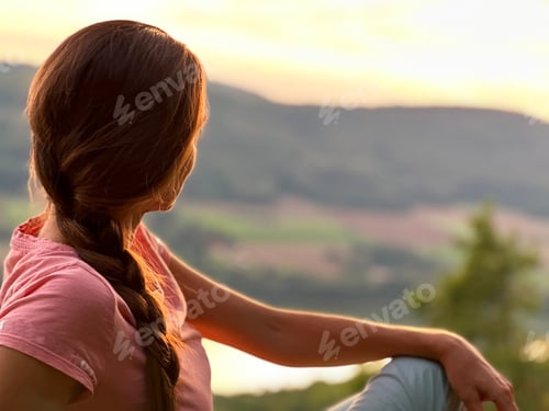 Preview: Silhouette Of A Young Woman With Long Hair Engoying Sunset In Front Of Mountains Landscape