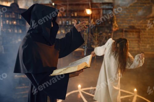 Preview: Exorcist in hood casting out demons from a woman