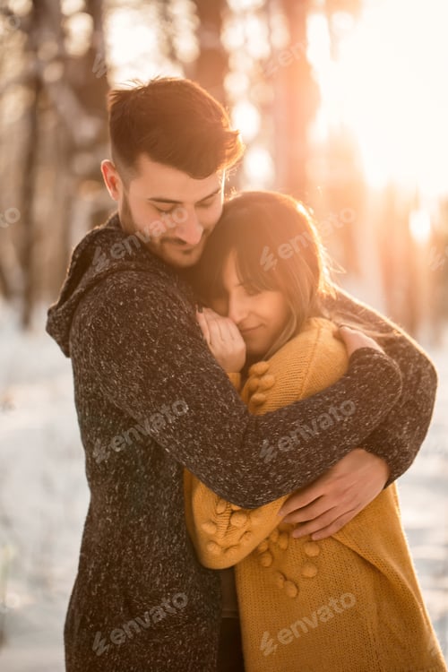 Preview: couple in love hugging in winter scenery
