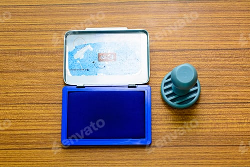 Preview: Top view ink pad and rubber stamp on a wooden background