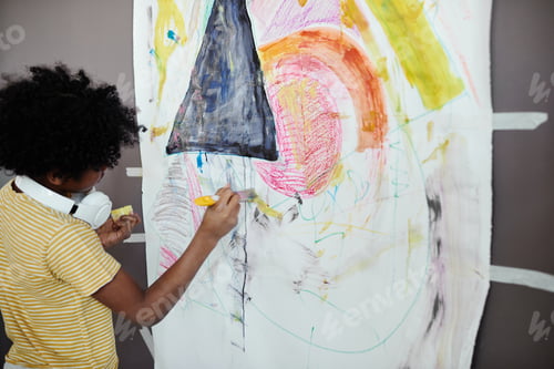 Preview: Little boy painting a picture on the wall
