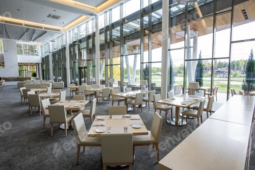 Preview: Two rows of tables served for guests in luxurious restaurant of business center
