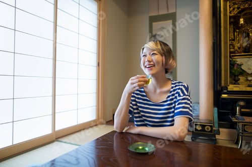 Preview: A woman sitting at a table.