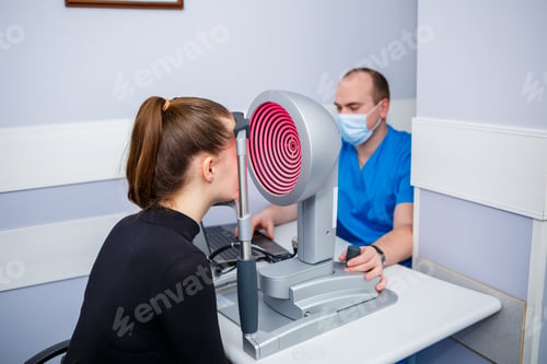 Preview: An optometrist at his clinic studies vision. Ophthalmology, medical diagnostics.