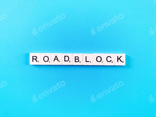 Preview: Roadblock Spelled Out with Letter Tiles on Blue