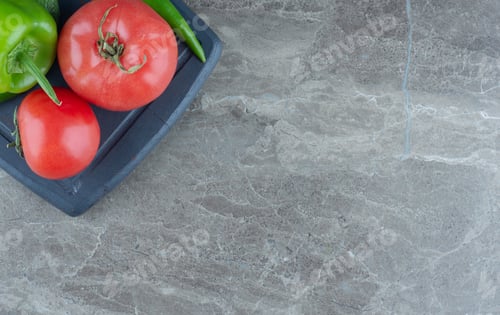 Preview: Tomatoes and peppers on the tray , on the marble background