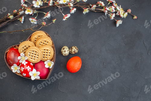 Preview: top view colored easter eggs with cookies inside heart shaped box on dark surface ornate spring