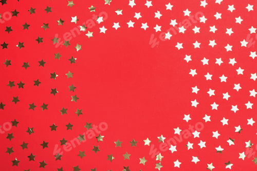 Preview: Frame of confetti stars with space for text on red background, top view. Christmas celebration