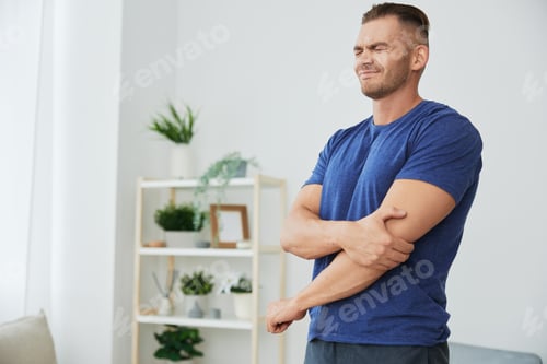 Preview: A man has pain in his arm, sprain of muscles and ligaments during sports, inflammation and injury