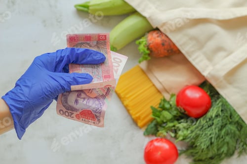 Preview: A hand in a rubber glove holds banknotes.