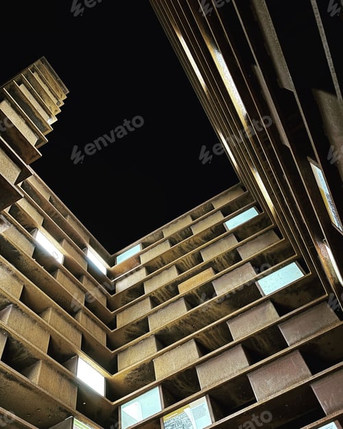 Preview: Towering concrete structure, featuring numerous windows, situated in an urban environment
