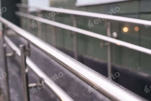 Preview: Modern stainless steel handrails along a ramp with glass background