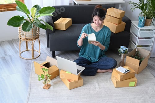 Preview: Young start up small business entrepreneur sitting in her home office.