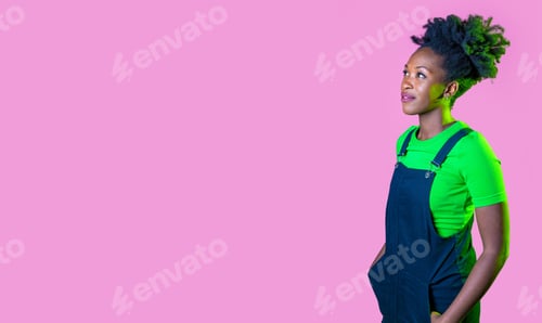 Preview: Studio portrait young black woman looking over positive and contemplative daydreaming