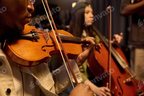 Preview: Young Black Man and Hispanic Girl Playing Violin and Cello in Music Studio