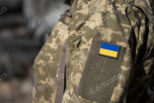 Preview: Ukrainian flag on a military uniform, war. Soldier Armed Forces of Ukraine. Territorial defense