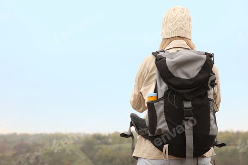 Preview: Traveler with backpack enjoying beautiful view on sunny day. Autumn vacation