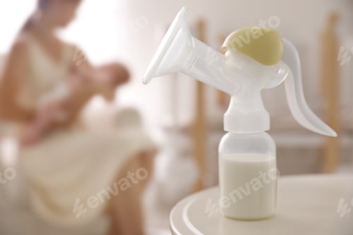 Preview: Mother and little baby indoors, focus on table with breast pump