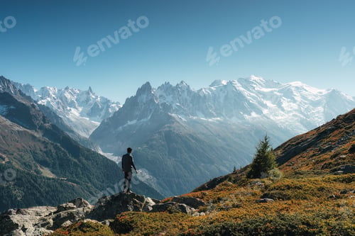 Preview: Male traveler standing with enjoying the Mont Blanc massif during trail among the French Alps