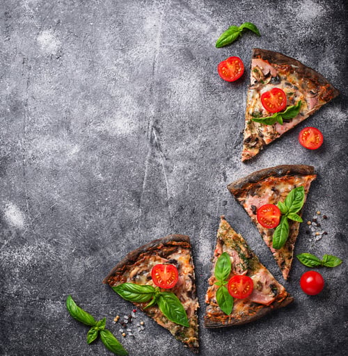 Preview: Pieces of black pizza with tomatoes and basil