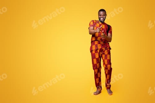 Preview: Handsome black guy in authentic clothes flirting over yellow