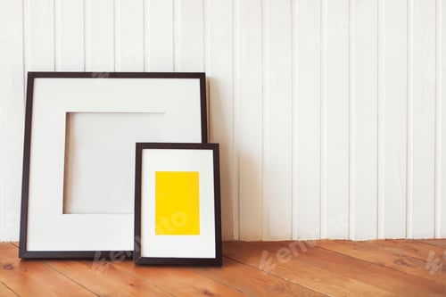 Preview: Two posters on the wooden floor by the white wall