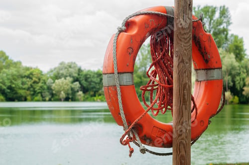 Preview: lifebuoy on wooden post by lake