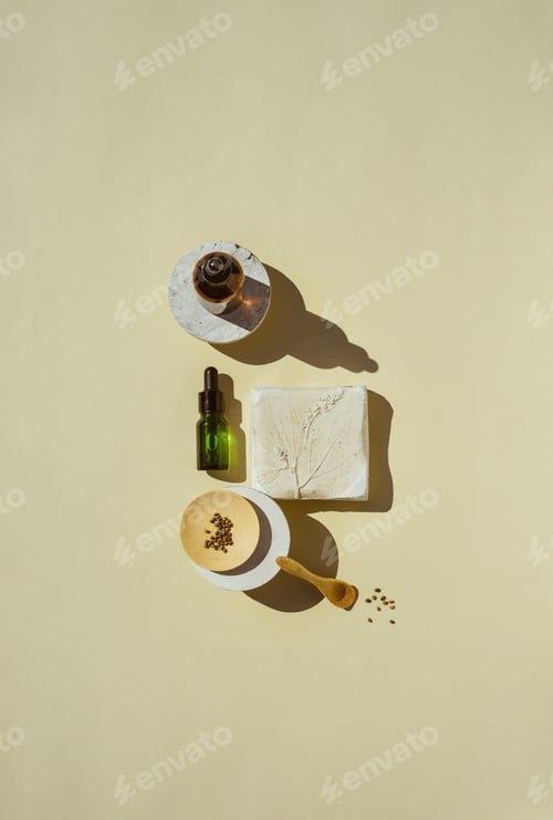 Preview: CBD oil, serums and tincture in bottles on geometric stand, flat lay