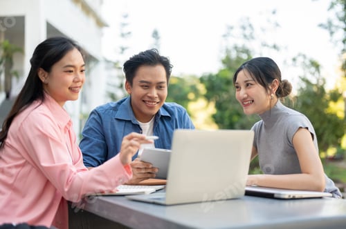 Preview: Man women asian student friends looking at laptop aside books working on group project at university