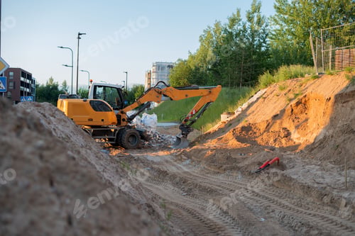 Preview: Excavator operating at sunset in a residential area, amid dirt and greenery, showing urban developme