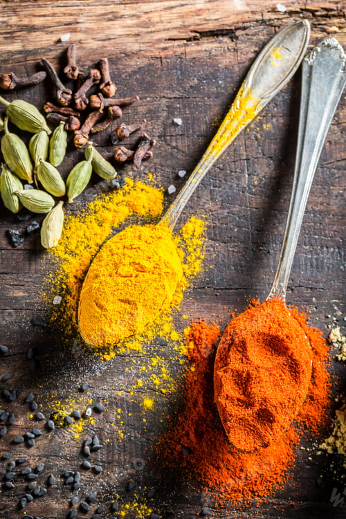 Preview: Closeup of colorful condiments on old wooden table