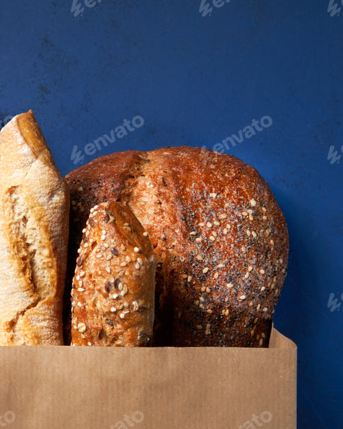 Preview: Assortment of baked bread, Crusty French Baguette, brown and white wheat grain loaves.