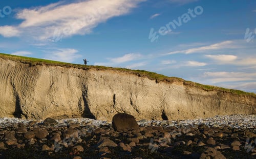 Preview: Silhouetted man on edge of the cliff