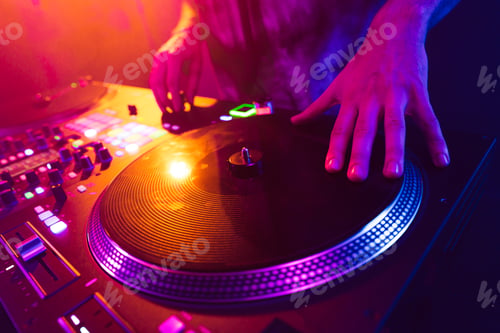 Preview: Close up of DJ hands on dj console mixer during concert in the club