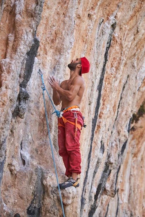 Preview: Shirtless climber standing on rocky slope