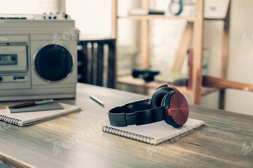 Preview: Headphones and record player on wooden desk table. Сomposer or music creative concept