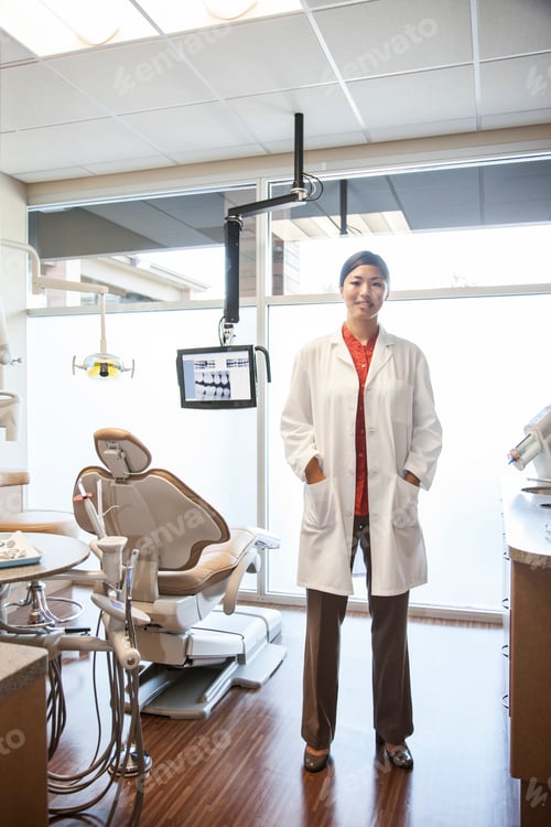 Preview: A portrait of an Asian female dentist in her office.