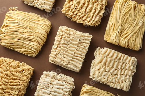 Varied Blocks of Raw Noodles on Brown Background