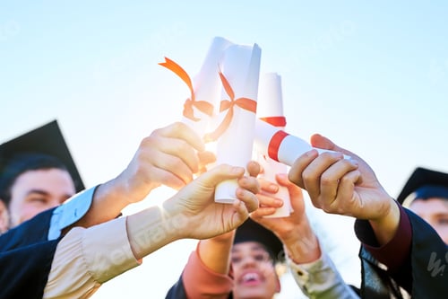 Preview: Shot of a group of students holding their diplomas together on graduation day