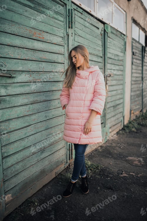 Preview: Young gorgeous blonde girl dressed fashion pink jacket and blue jeans