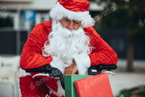 Preview: Santa claus supported in a bicycle full of gifts with exhausted expression. Christmas time