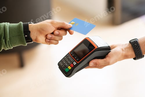 Preview: Cropped of man customer paying with credit card