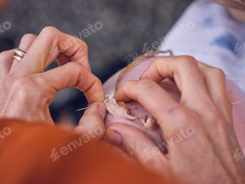 Preview: elderly woman making sausage