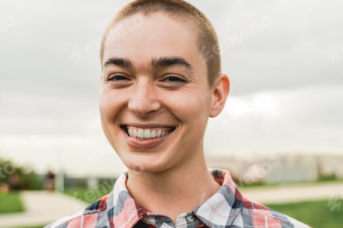 Preview: Happy young bald woman looking at camera outdoor - Authentic and real people concept