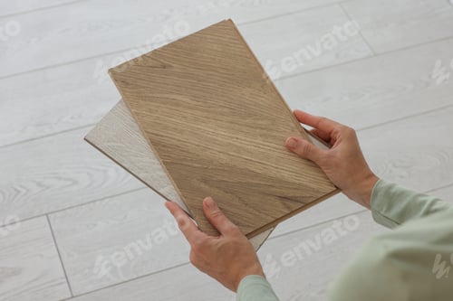Preview: Woman with samples of wooden flooring indoors, closeup