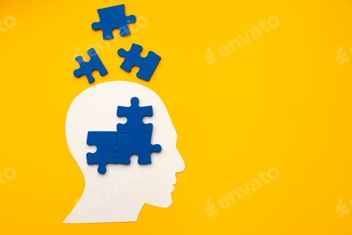 Preview: Papercut head silhouette with puzzle pieces on yellow background