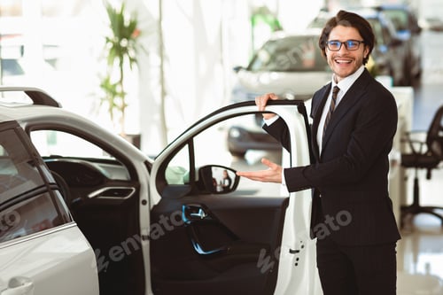 Preview: Dealer Showing New Automobile Opening Door In Dealership Center