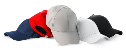 Preview: Colorful Assortment of Baseball Caps and a Ball on White Background